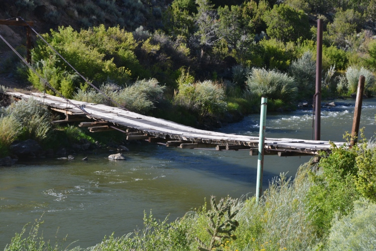 an old wooden plank bridge over the river